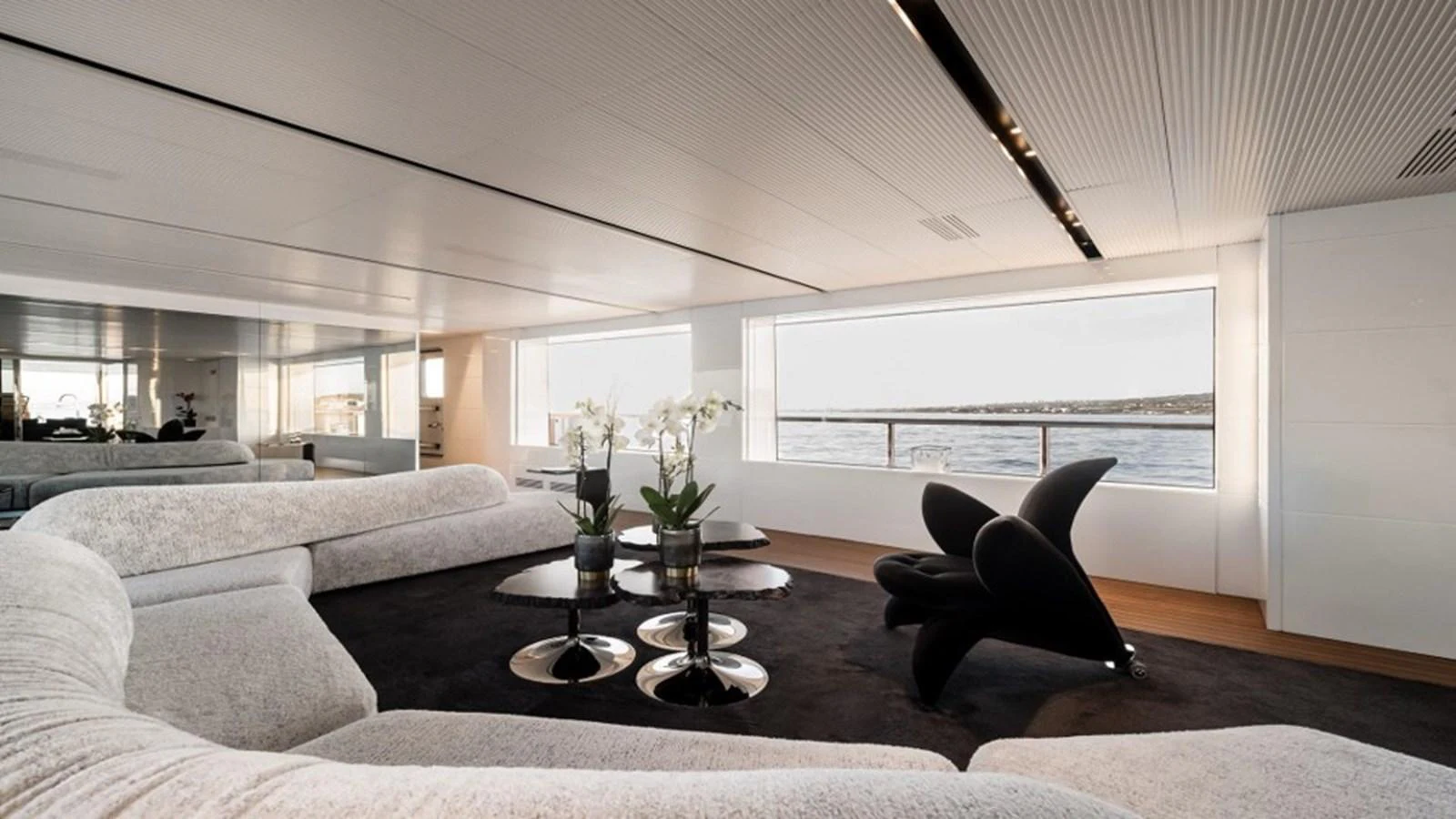 The salon features modern furnishings with large windows offering stunning sea views. aboard R23 Yacht for Sale