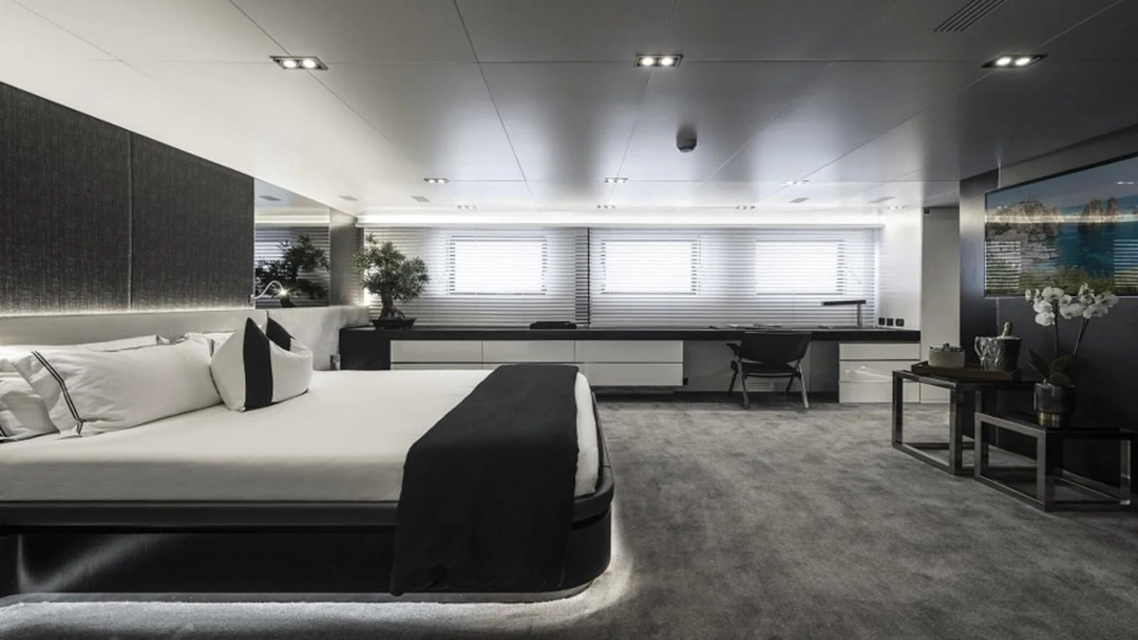 The master stateroom features a luxurious bed, modern decor, and ample natural light. aboard R23 Yacht for Sale