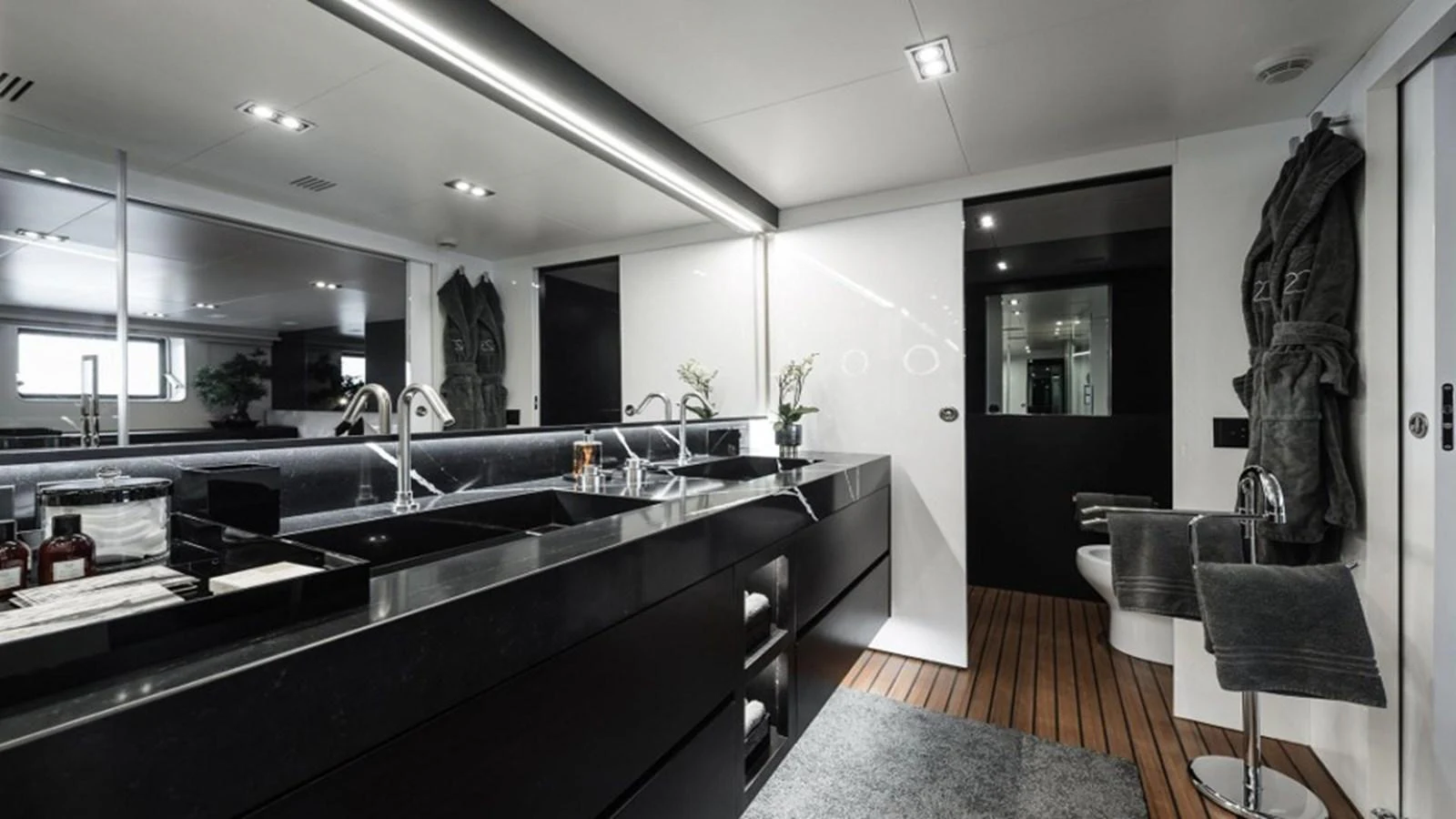 The yacht's bathroom features sleek black fixtures and modern design elements. aboard R23 Yacht for Sale
