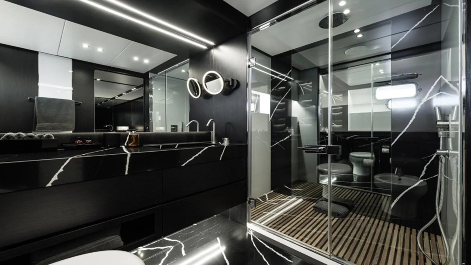 A luxurious yacht bathroom featuring modern fixtures and sleek black marble surfaces. aboard R23 Yacht for Sale