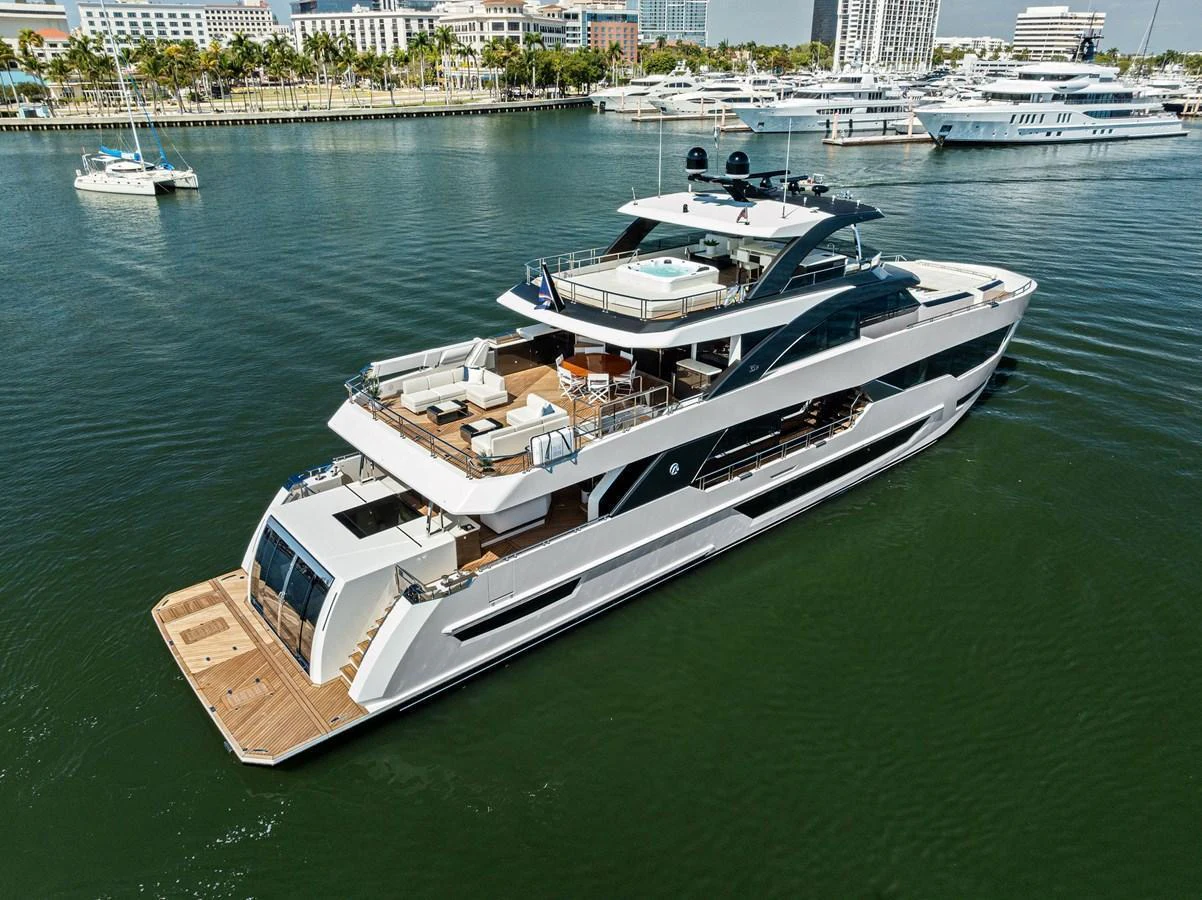 A sleek and modern yacht cruising in a marina with luxurious amenities visible on the decks. aboard SERENITY NOW Yacht for Sale