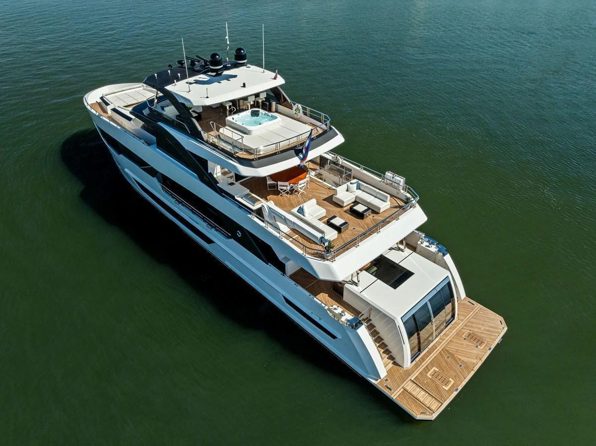 This luxurious yacht features an expansive aft deck with multiple lounging areas and a jacuzzi, perfect for relaxation and entertainment. aboard SERENITY NOW Yacht for Sale