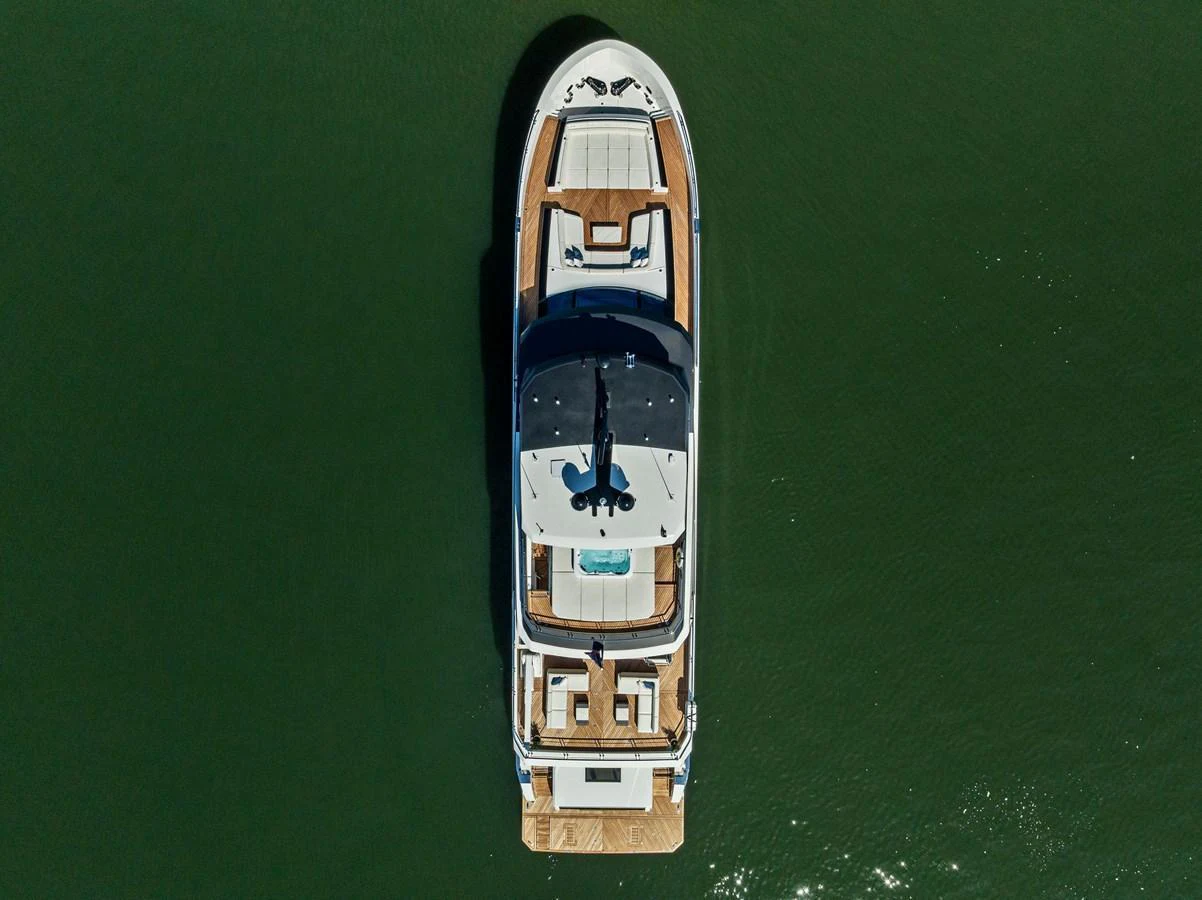 Aerial view of a luxurious yacht showcasing its spacious decks and elegant design on calm waters. aboard SERENITY NOW Yacht for Sale