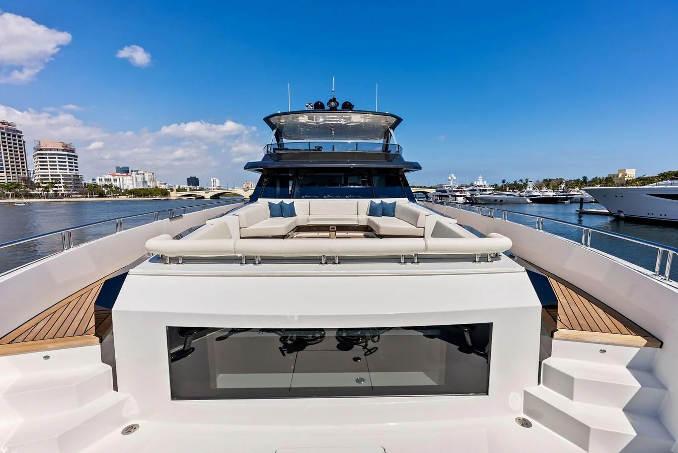The yacht's foredeck features a spacious seating area with plush cushions, perfect for relaxation and enjoying the view. aboard SERENITY NOW Yacht for Sale