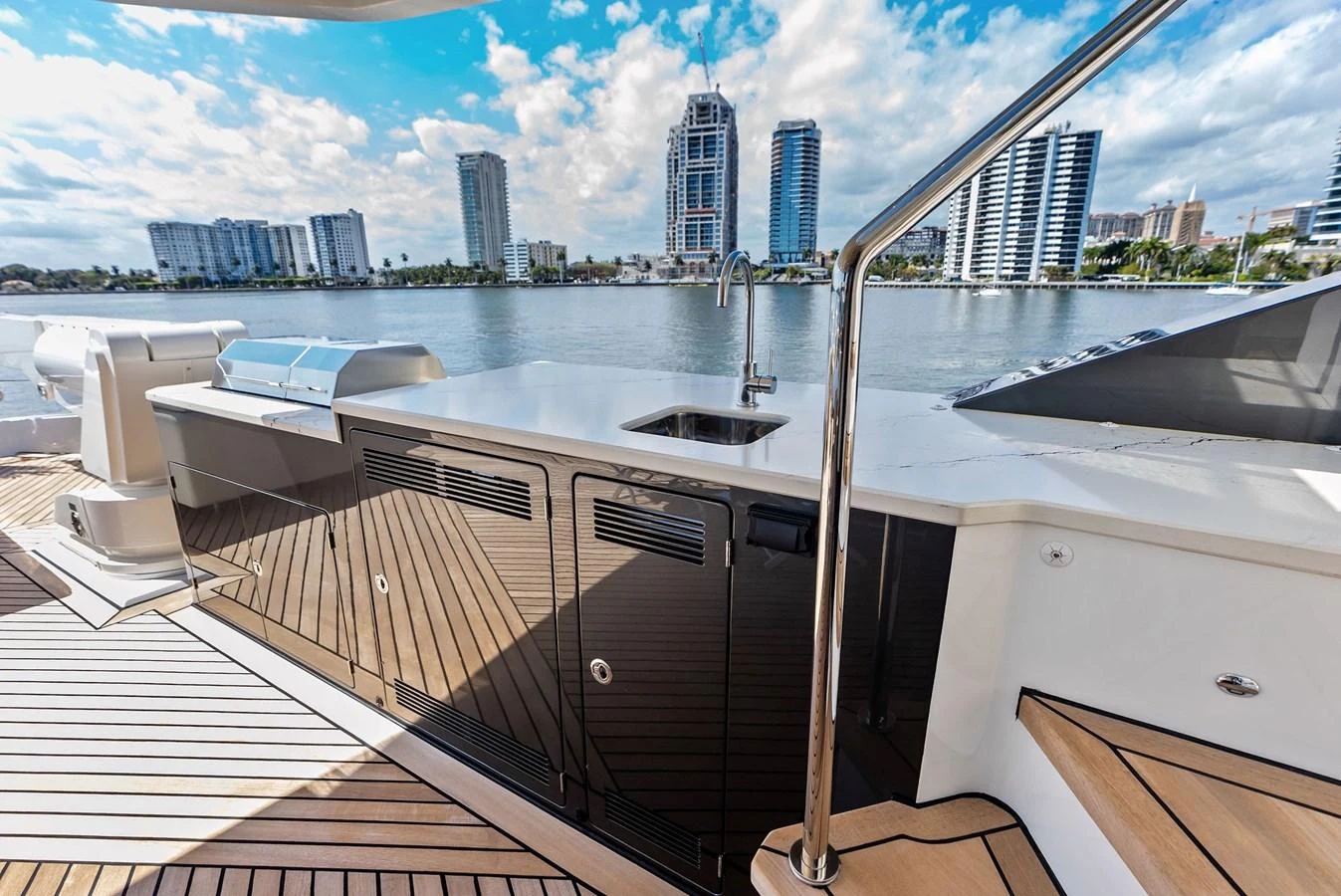 The yacht's outdoor galley offers a sleek and functional space with a stunning waterfront view. aboard SERENITY NOW Yacht for Sale