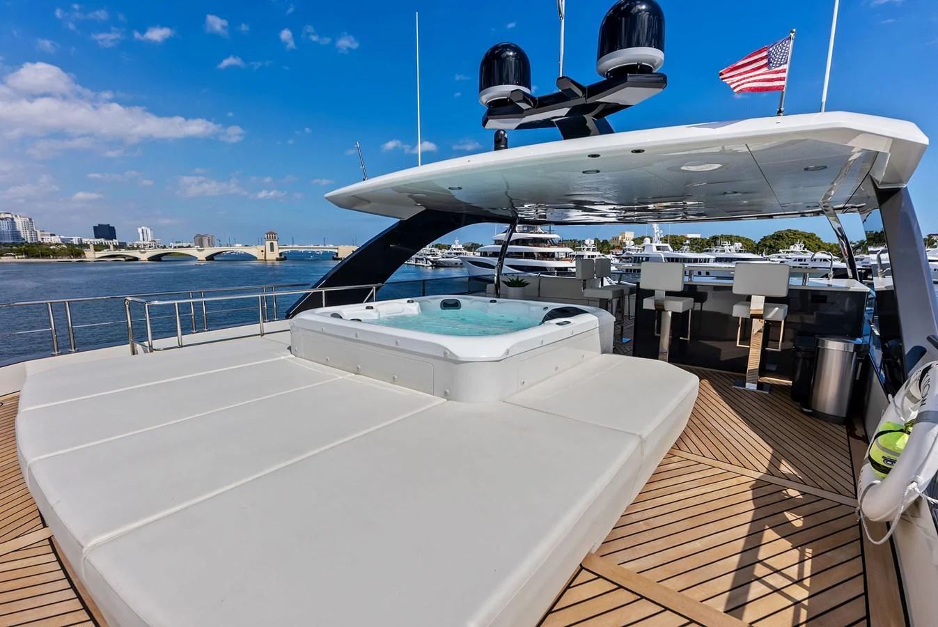 The sundeck features a luxurious hot tub with ample lounging space, perfect for relaxation while enjoying the view. aboard SERENITY NOW Yacht for Sale