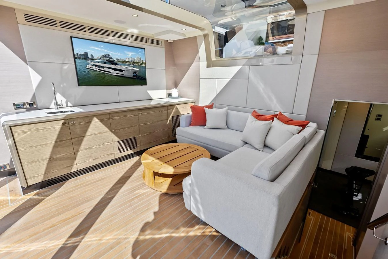 The salon features a comfortable seating area with a large TV and modern decor. aboard SERENITY NOW Yacht for Sale