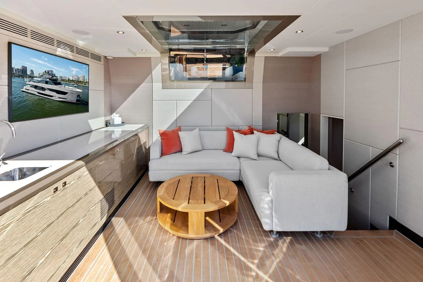 The yacht's salon features a comfortable seating area with a modern design and a large TV. aboard SERENITY NOW Yacht for Sale
