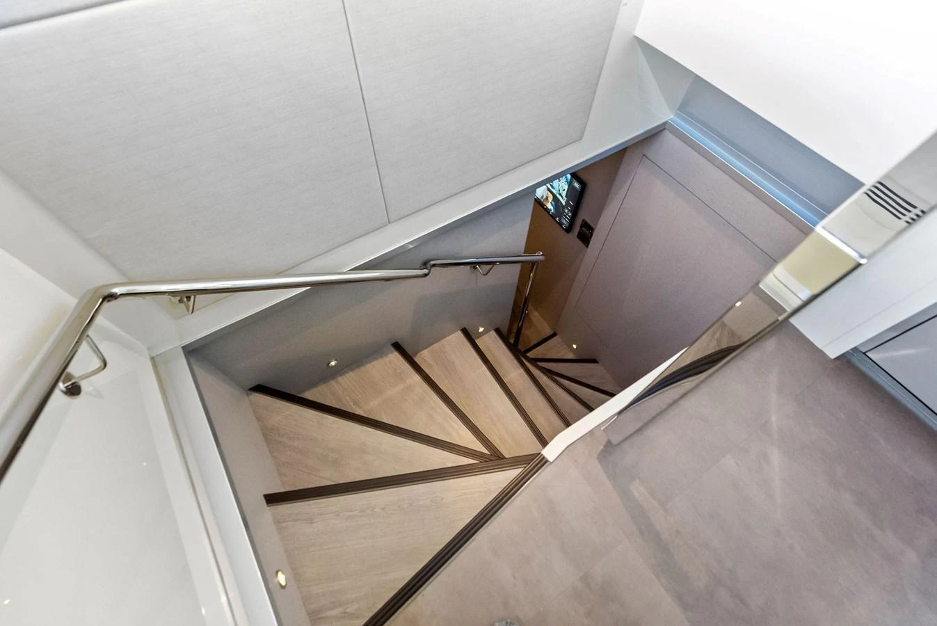 A sleek and modern staircase with clean lines and contemporary design. aboard SERENITY NOW Yacht for Sale