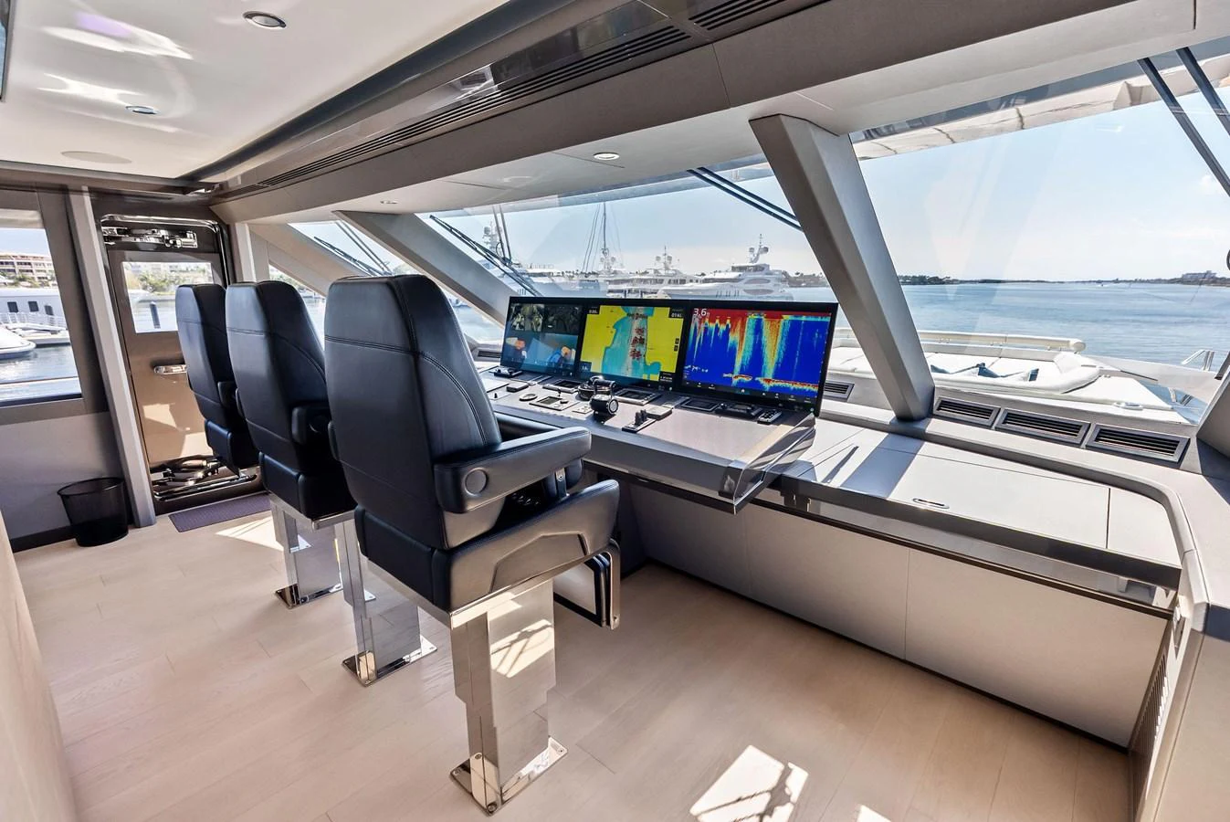 The helm station offers a modern and sophisticated command center with advanced navigation equipment and panoramic views. aboard SERENITY NOW Yacht for Sale