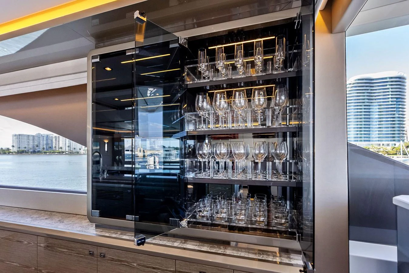 A sophisticated glassware cabinet showcases an array of wine glasses, adding a touch of elegance to the yacht's interior. aboard SERENITY NOW Yacht for Sale