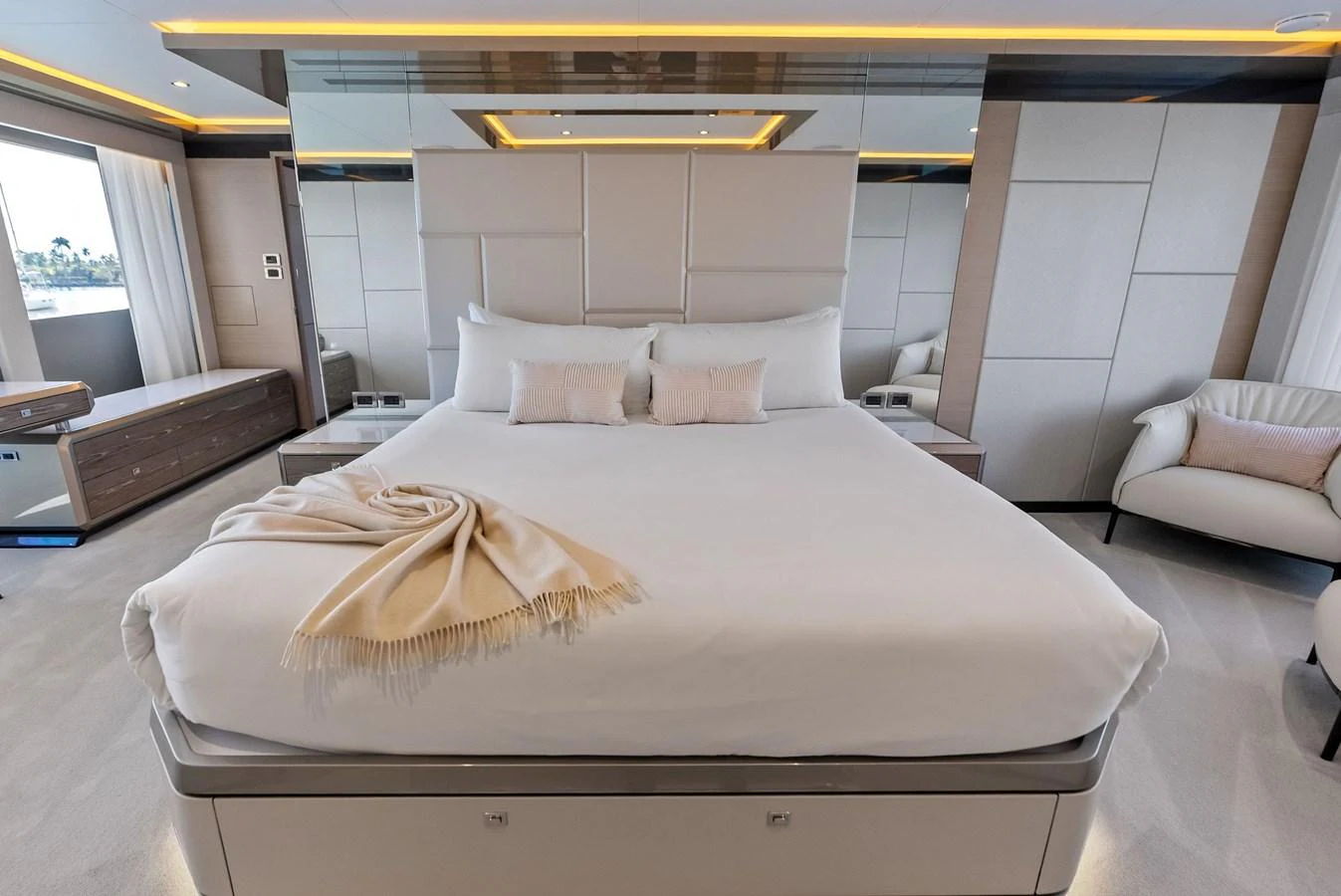 The master stateroom features a luxurious bed with elegant decor and ample natural light. aboard SERENITY NOW Yacht for Sale