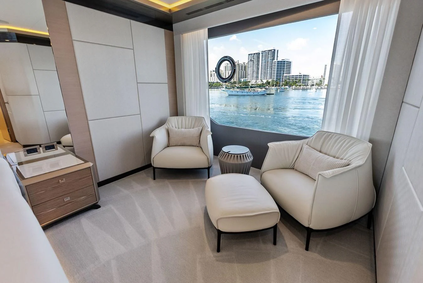 A cozy seating area with a scenic view through a large window. aboard SERENITY NOW Yacht for Sale