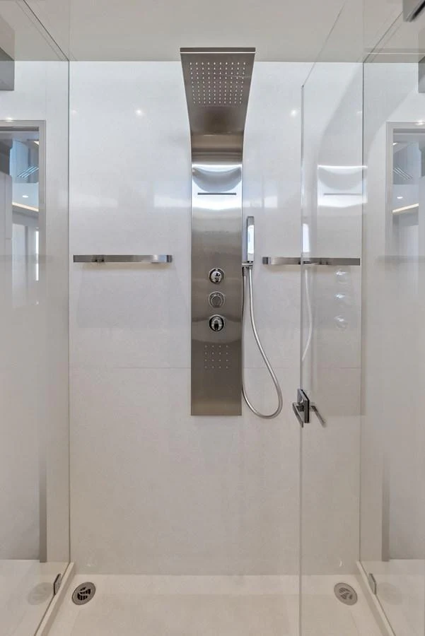 A sleek, modern shower with stainless steel fixtures and glass doors. aboard SERENITY NOW Yacht for Sale