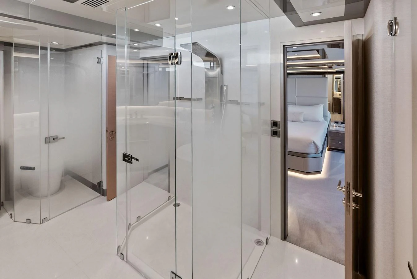 The yacht's bathroom features sleek glass partitions and modern fixtures, leading to a luxurious stateroom. aboard SERENITY NOW Yacht for Sale
