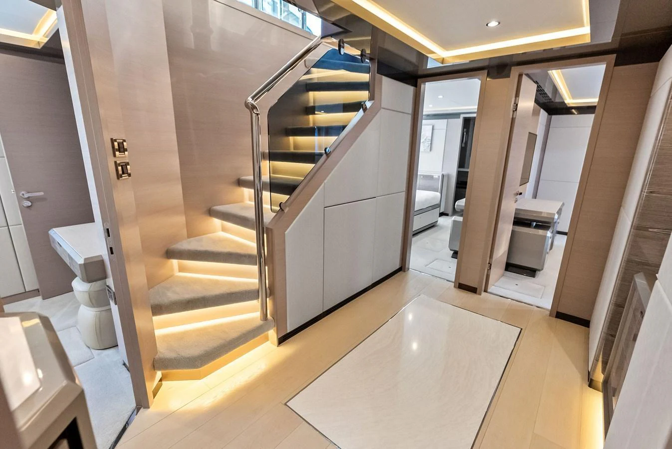The yacht's interior features a modern staircase with sleek lighting and elegant finishes. aboard SERENITY NOW Yacht for Sale