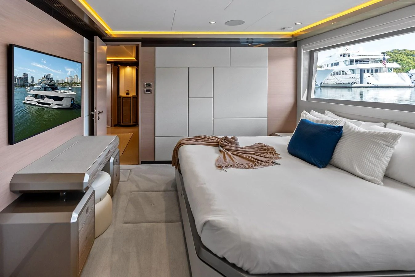 The stateroom offers a luxurious and comfortable sleeping area with a large window providing a scenic view. aboard SERENITY NOW Yacht for Sale