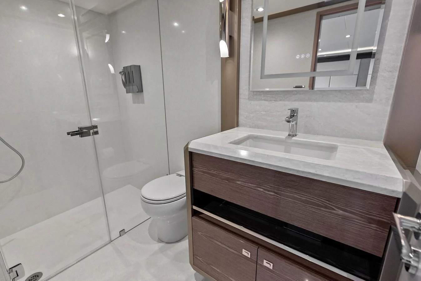 The yacht's bathroom features a sleek design with modern fixtures and a spacious shower area. aboard SERENITY NOW Yacht for Sale