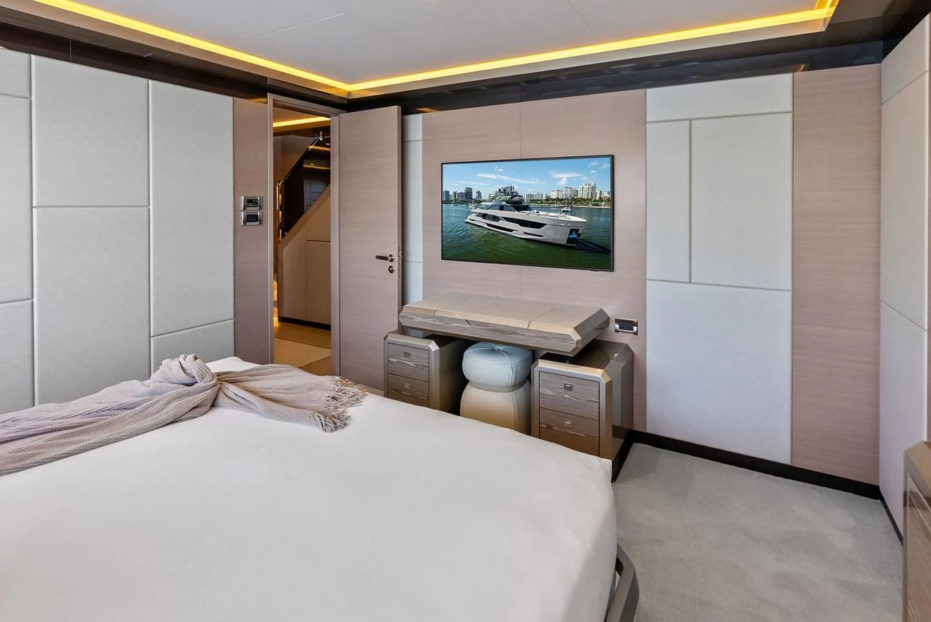 A luxurious stateroom featuring a large bed, modern decor, and a flat-screen TV. aboard SERENITY NOW Yacht for Sale