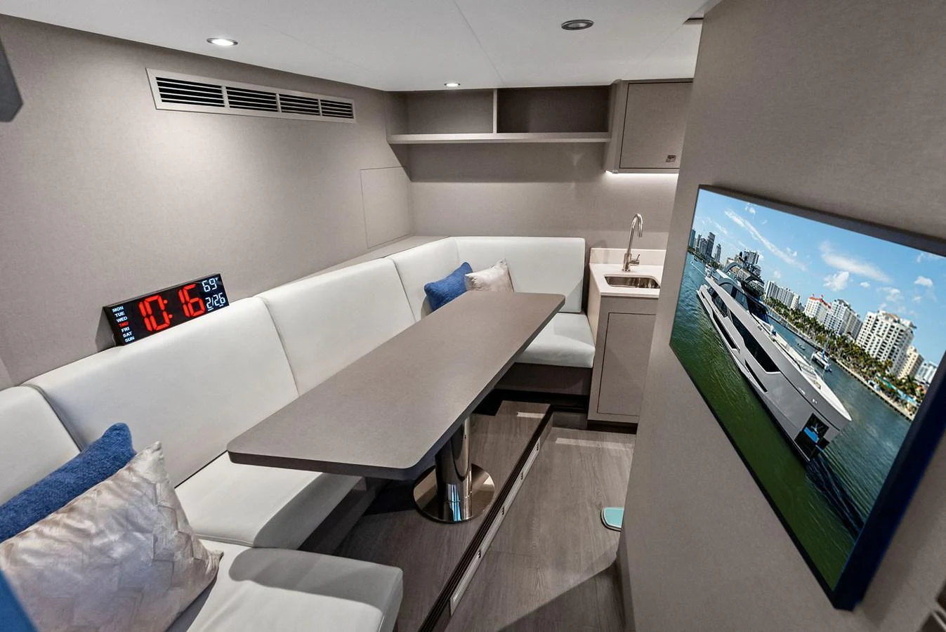 The saloon features a cozy seating area with a modern entertainment system and a compact kitchenette. aboard SERENITY NOW Yacht for Sale