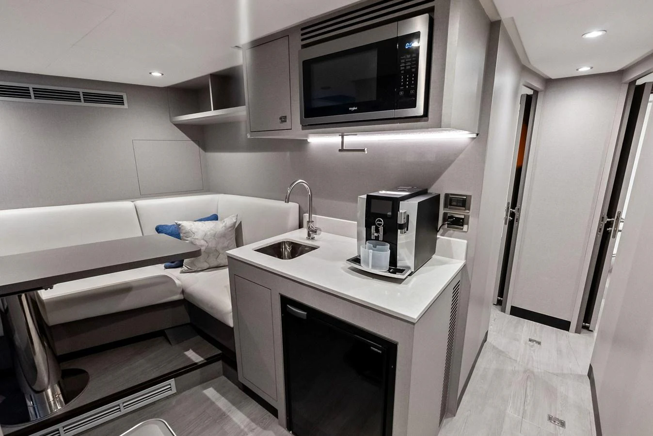 A sleek and modern galley with integrated appliances and a cozy dining nook. aboard SERENITY NOW Yacht for Sale