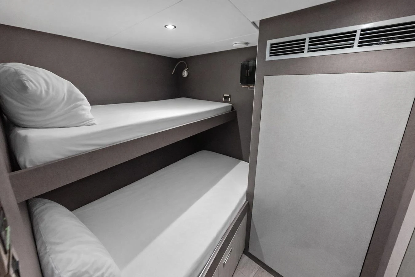The cozy bunk cabin features modern design and comfortable sleeping arrangements. aboard SERENITY NOW Yacht for Sale