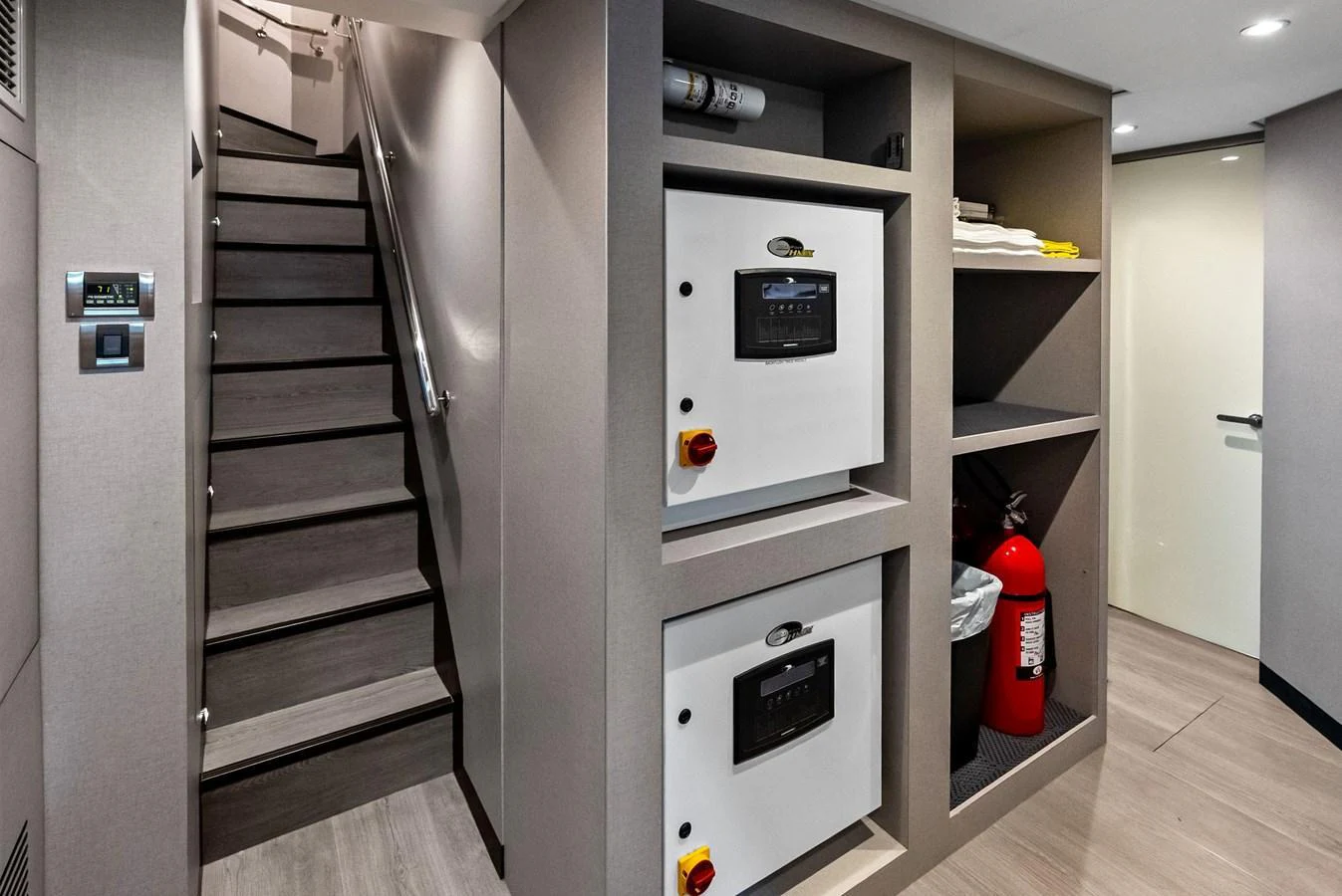 This image showcases the yacht's utility area, featuring essential equipment and a staircase leading to another level. aboard SERENITY NOW Yacht for Sale