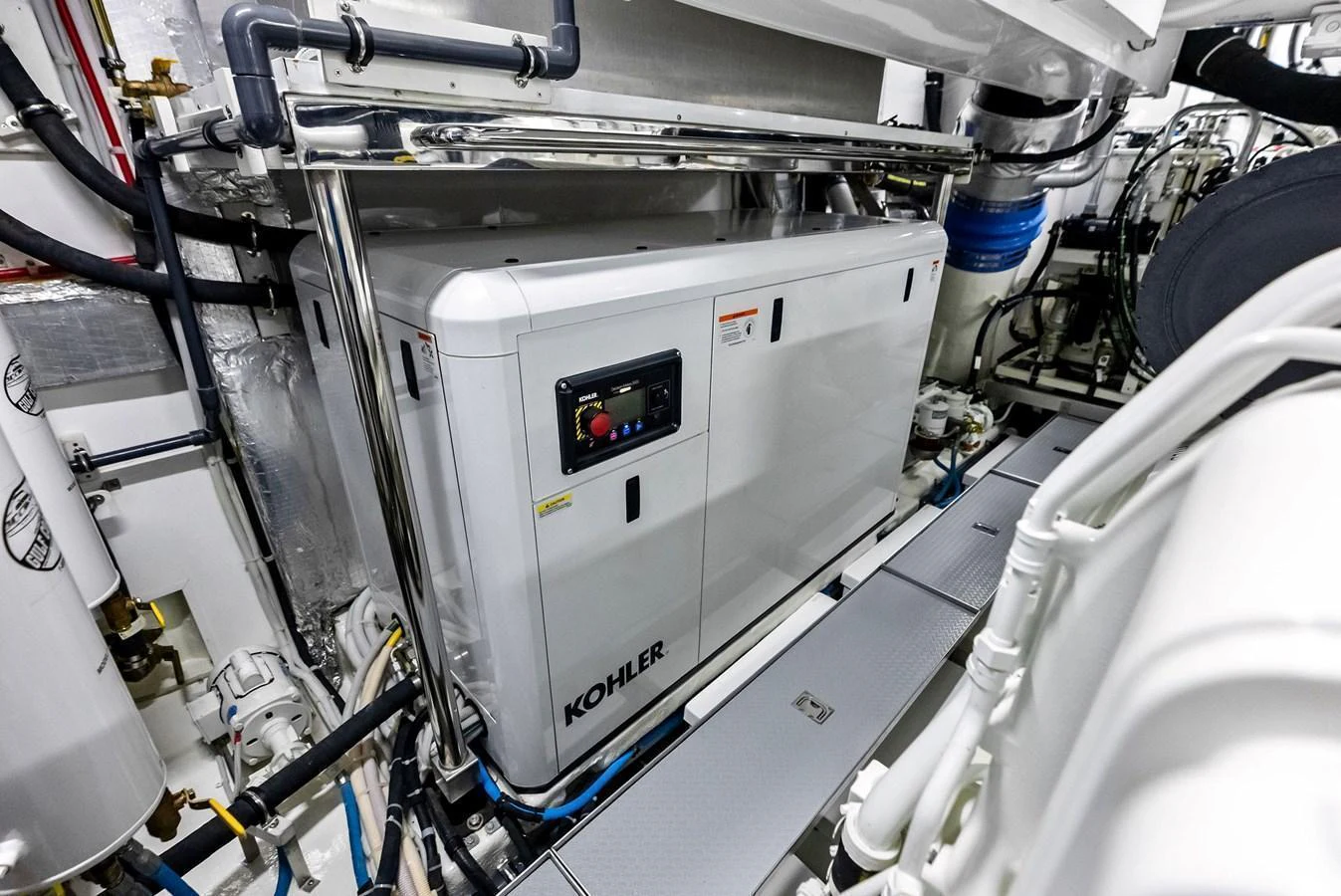 The yacht's engine room features a Kohler generator and various mechanical components. aboard SERENITY NOW Yacht for Sale