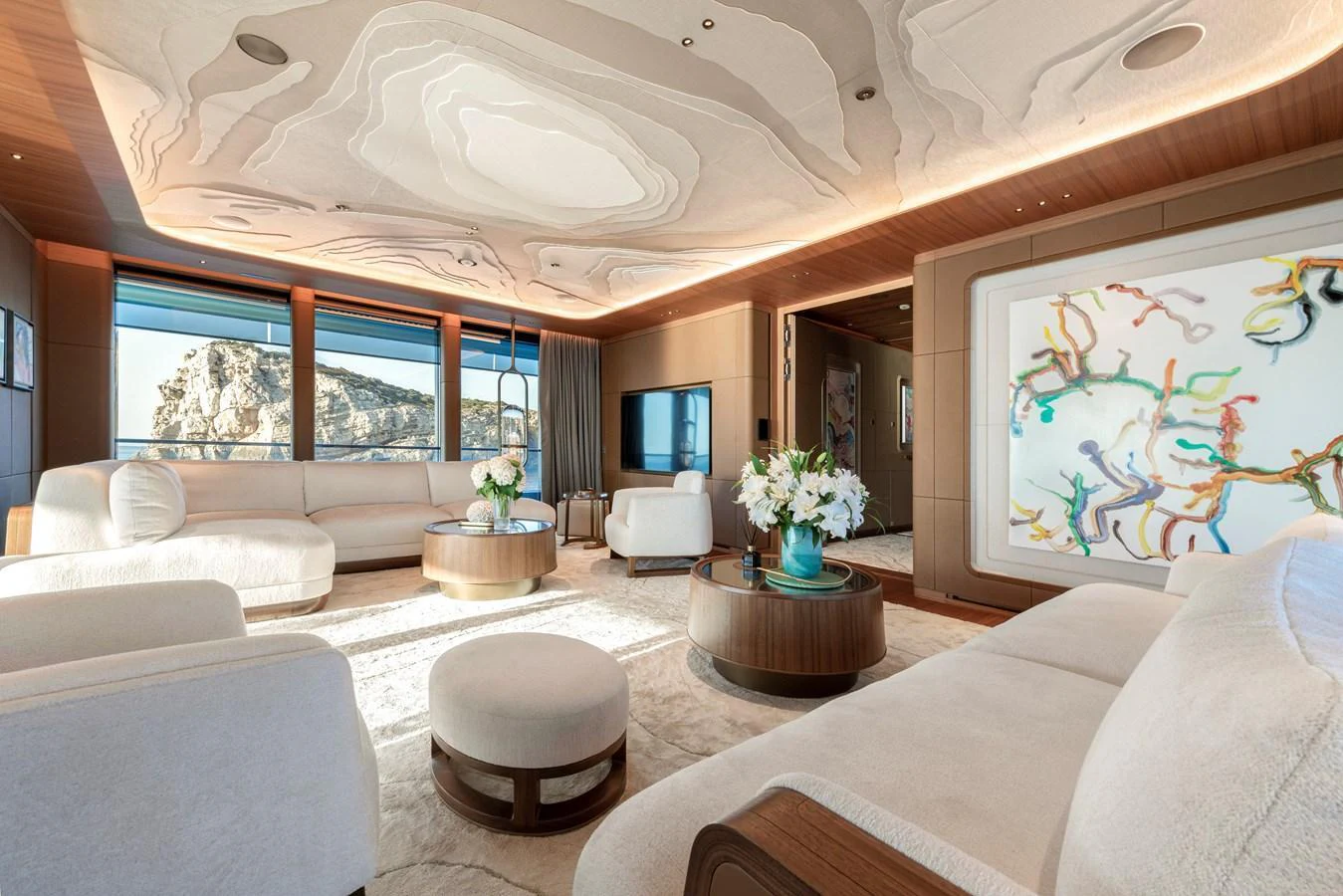 The salon features luxurious seating with modern decor and expansive windows offering stunning views. aboard KENSHO Yacht for Sale