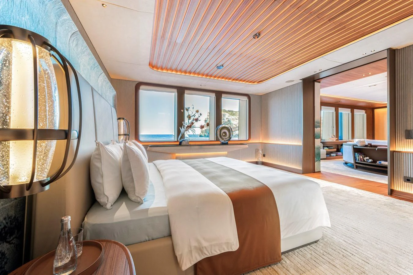 The master stateroom features a luxurious bed with elegant decor and a stunning view through large windows. aboard KENSHO Yacht for Sale