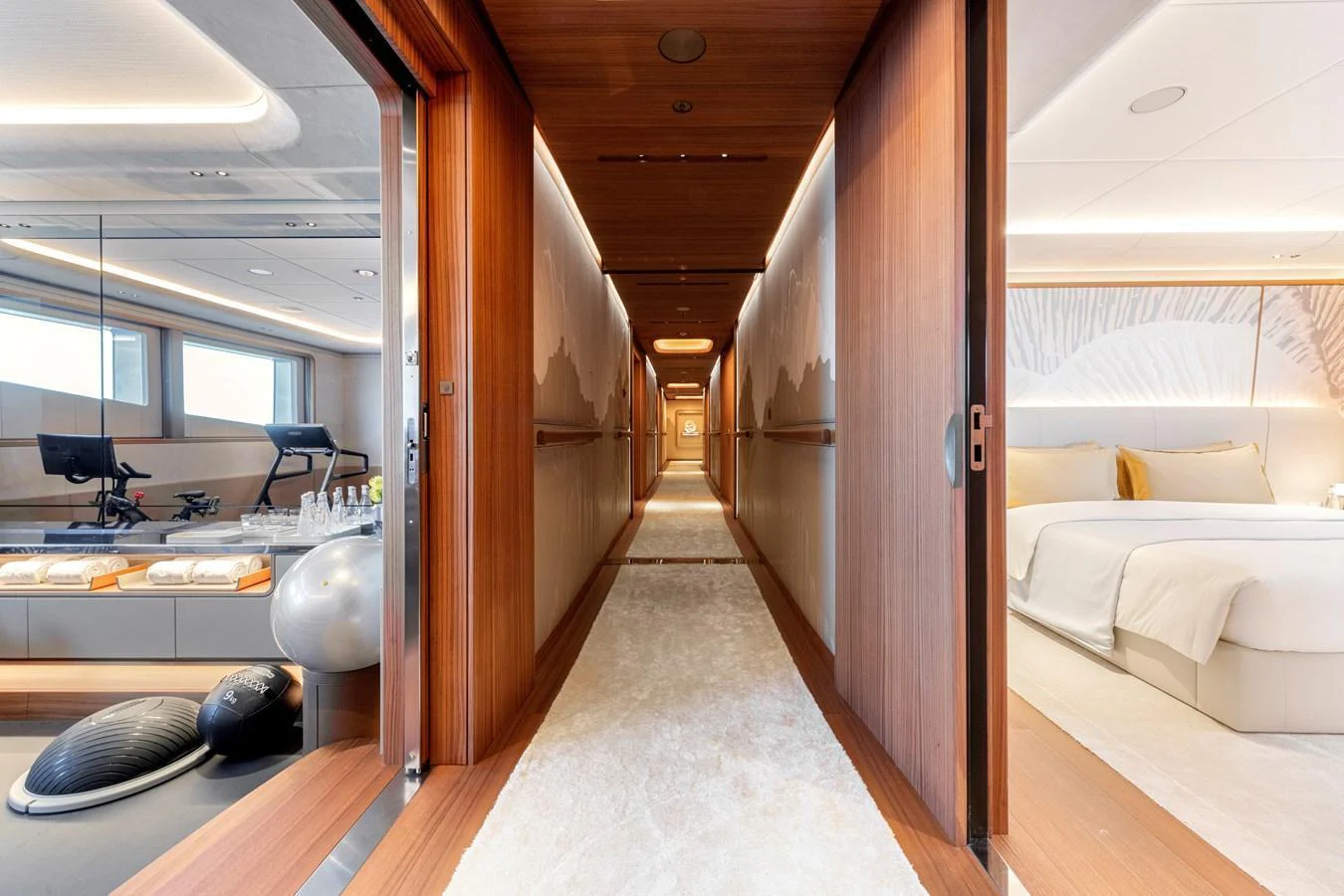 A luxurious hallway with access to a fitness area and a serene bedroom. aboard KENSHO Yacht for Sale