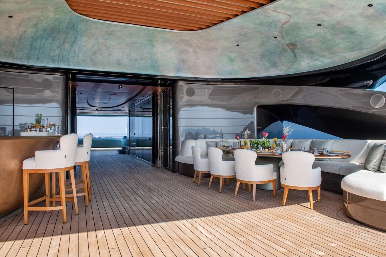 The aft deck features a stylish dining area with a bar and comfortable seating, perfect for alfresco dining. aboard KENSHO Yacht for Sale