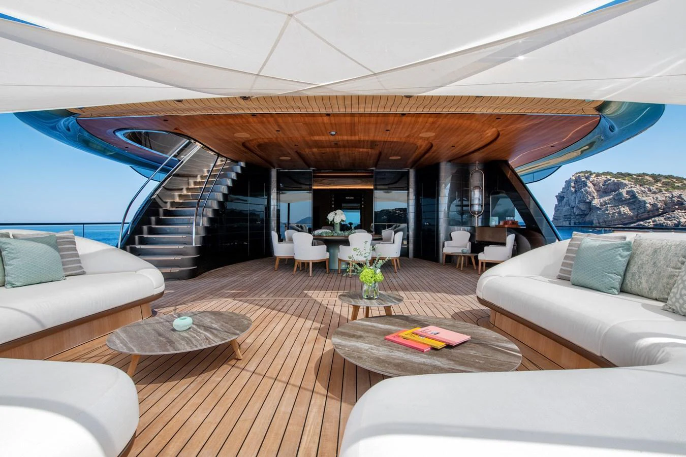 The aft deck features luxurious seating and dining areas with stunning ocean views. aboard KENSHO Yacht for Sale
