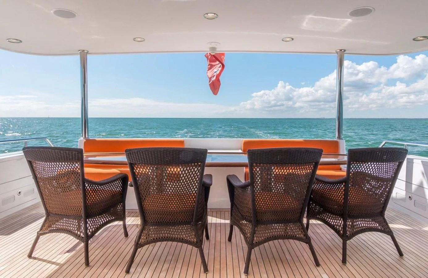 The aft deck offers a serene seating area with a stunning ocean view. aboard ROBIN'S NEST Yacht for Sale