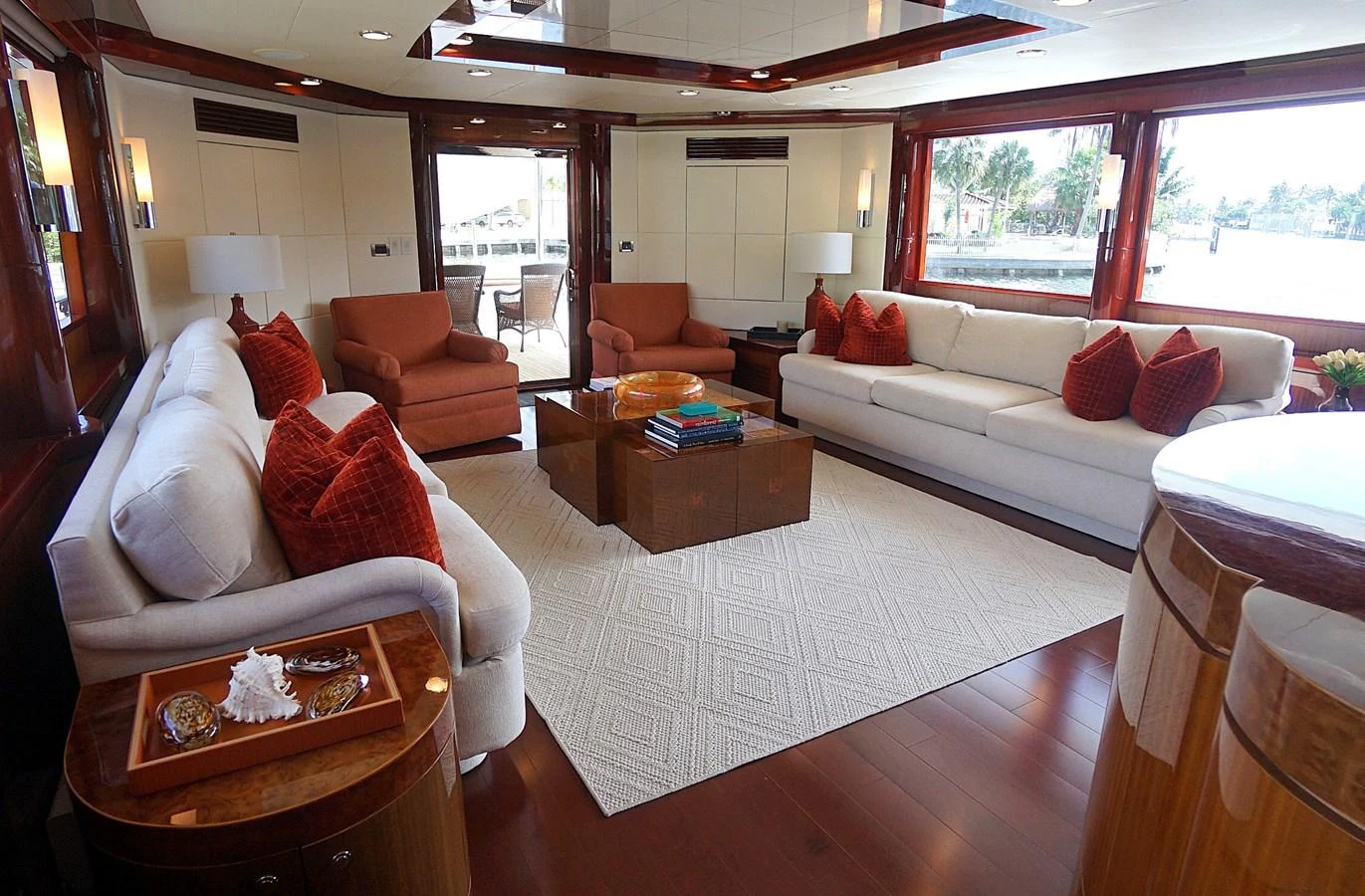 The salon features plush seating, warm wood finishes, and large windows offering panoramic views. aboard ROBIN'S NEST Yacht for Sale