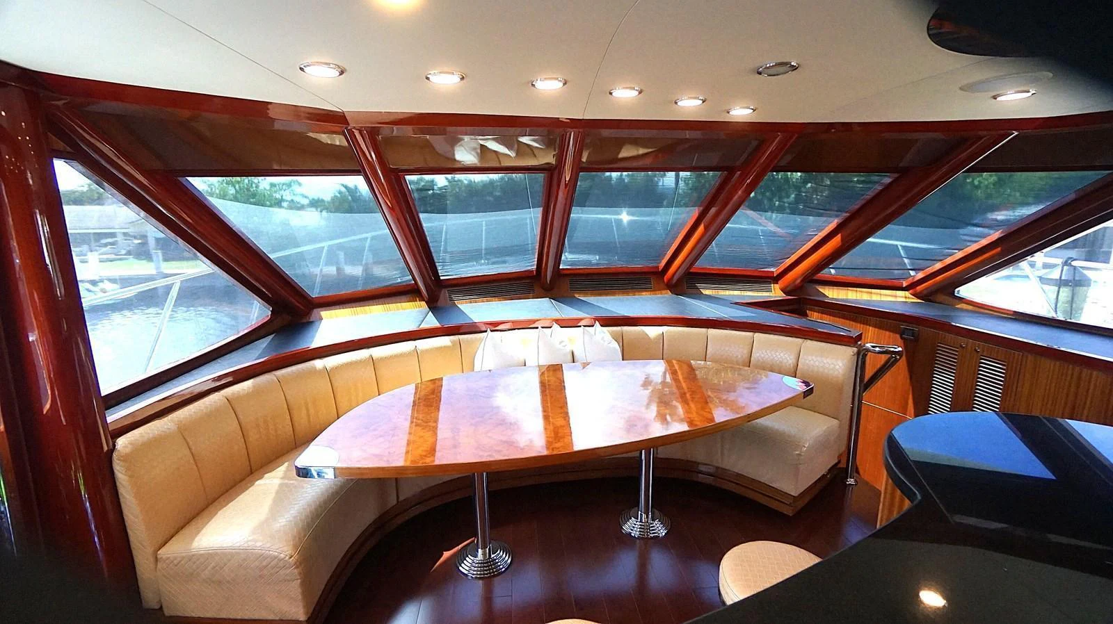 The yacht's salon features a spacious seating area with panoramic windows and elegant wood finishes. aboard ROBIN'S NEST Yacht for Sale