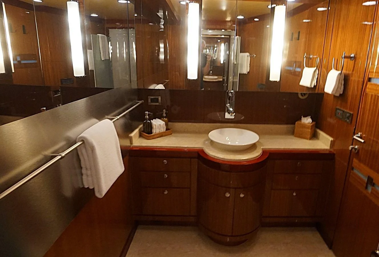 A luxurious yacht bathroom featuring elegant wood finishes and modern fixtures. aboard ROBIN'S NEST Yacht for Sale