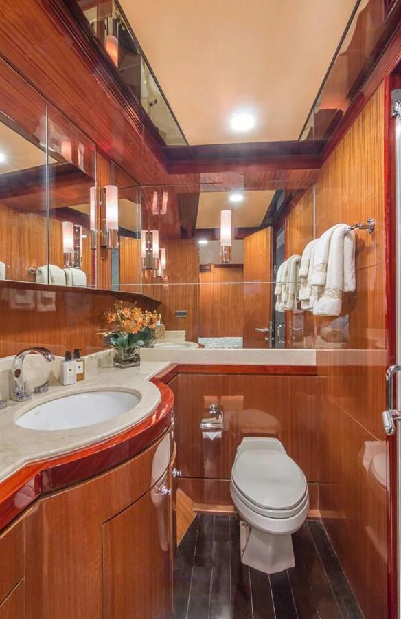 A luxurious yacht bathroom featuring elegant wood paneling and modern fixtures. aboard ROBIN'S NEST Yacht for Sale