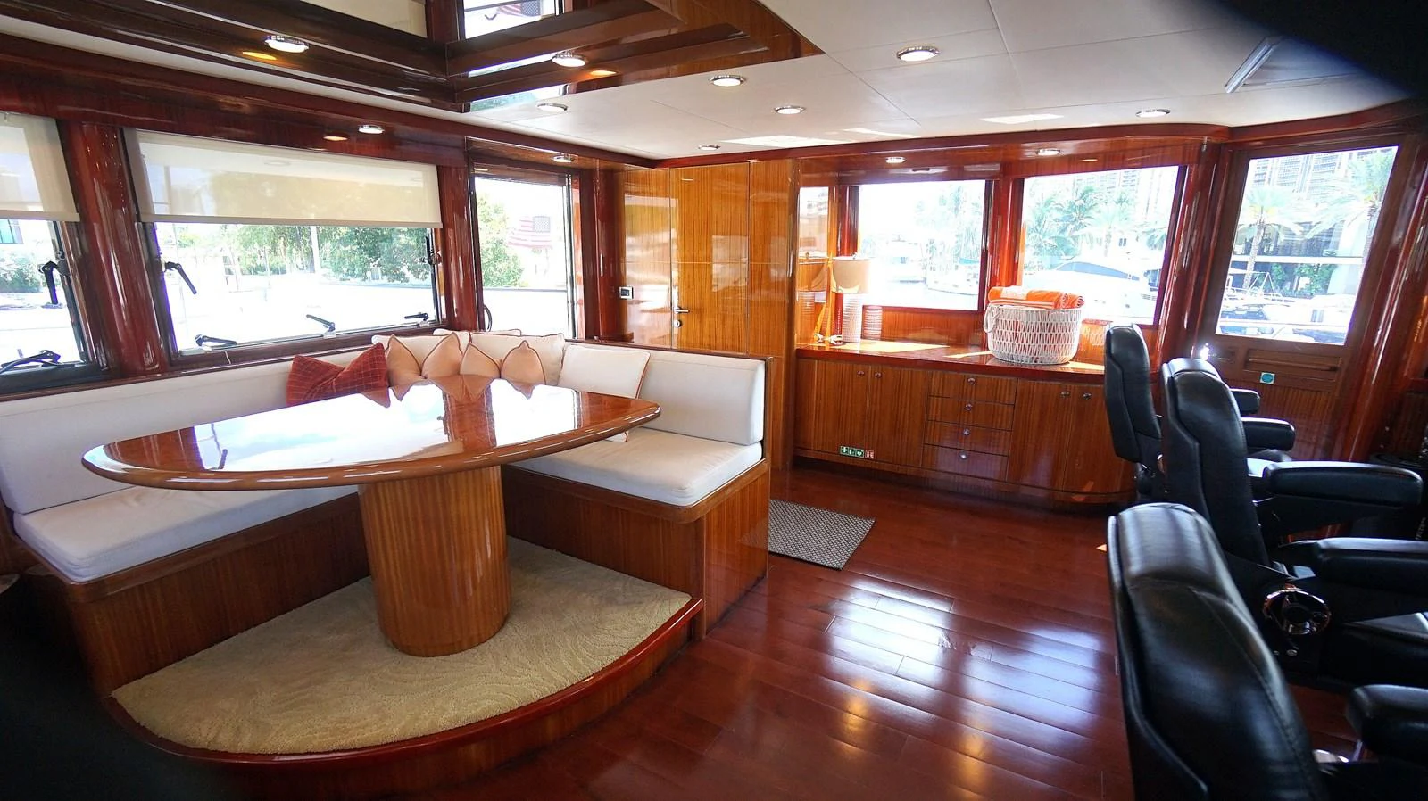 The yacht's salon features elegant wood paneling, plush seating, and ample natural light. aboard ROBIN'S NEST Yacht for Sale