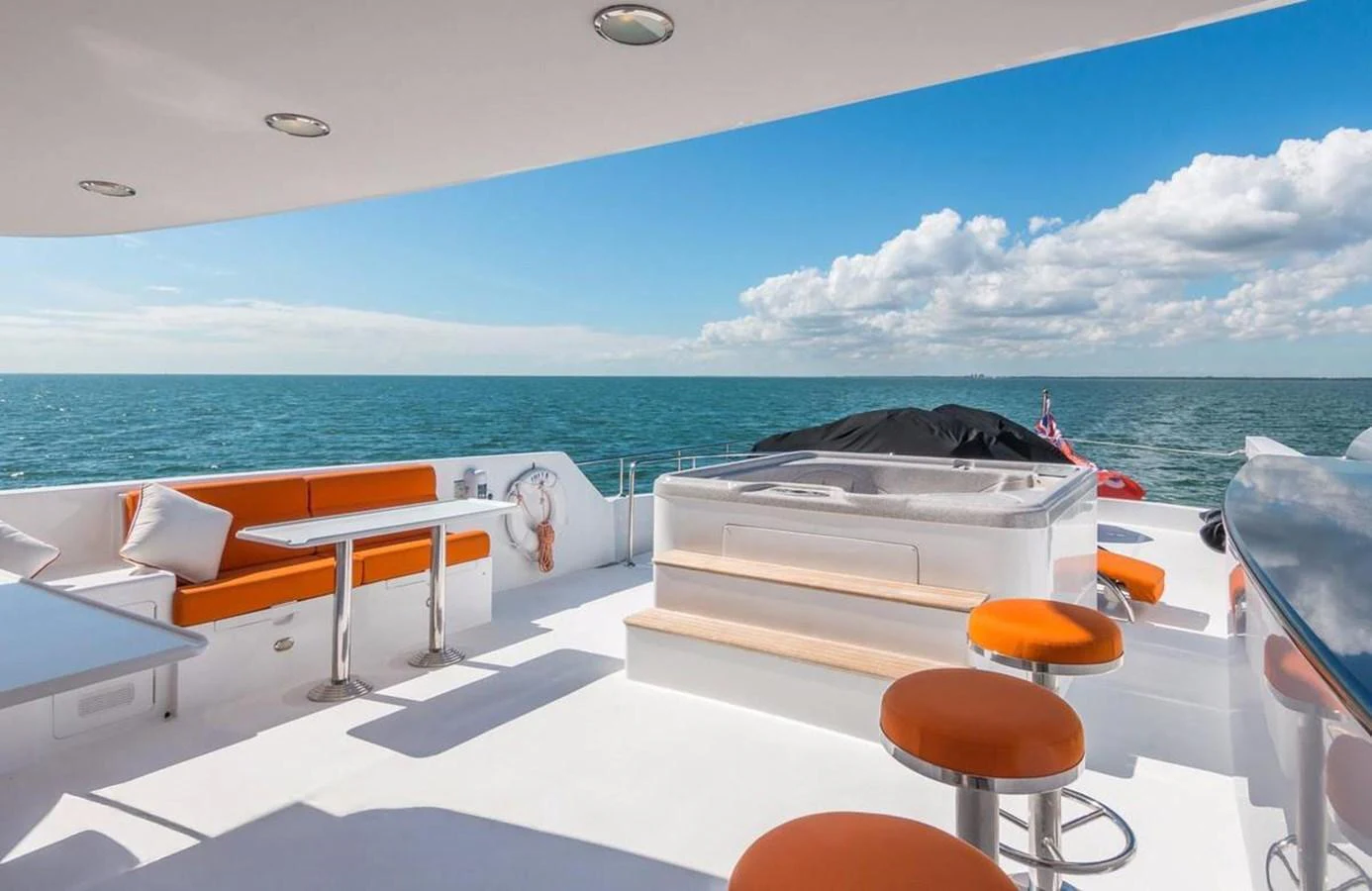 The sundeck features a luxurious hot tub and comfortable seating with stunning ocean views. aboard ROBIN'S NEST Yacht for Sale