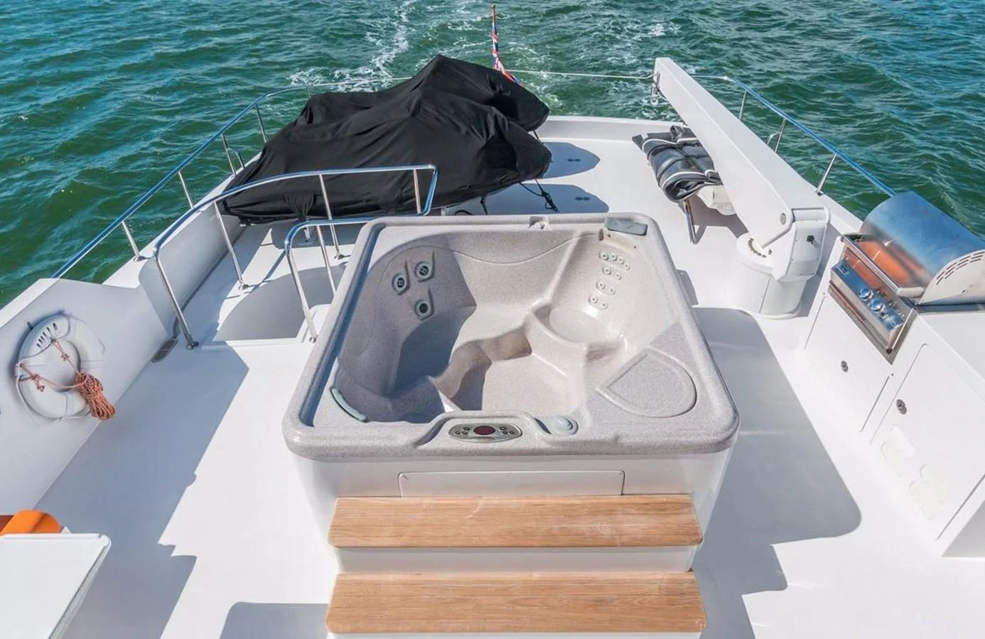 The sundeck features a luxurious hot tub with ample seating and stunning ocean views. aboard ROBIN'S NEST Yacht for Sale