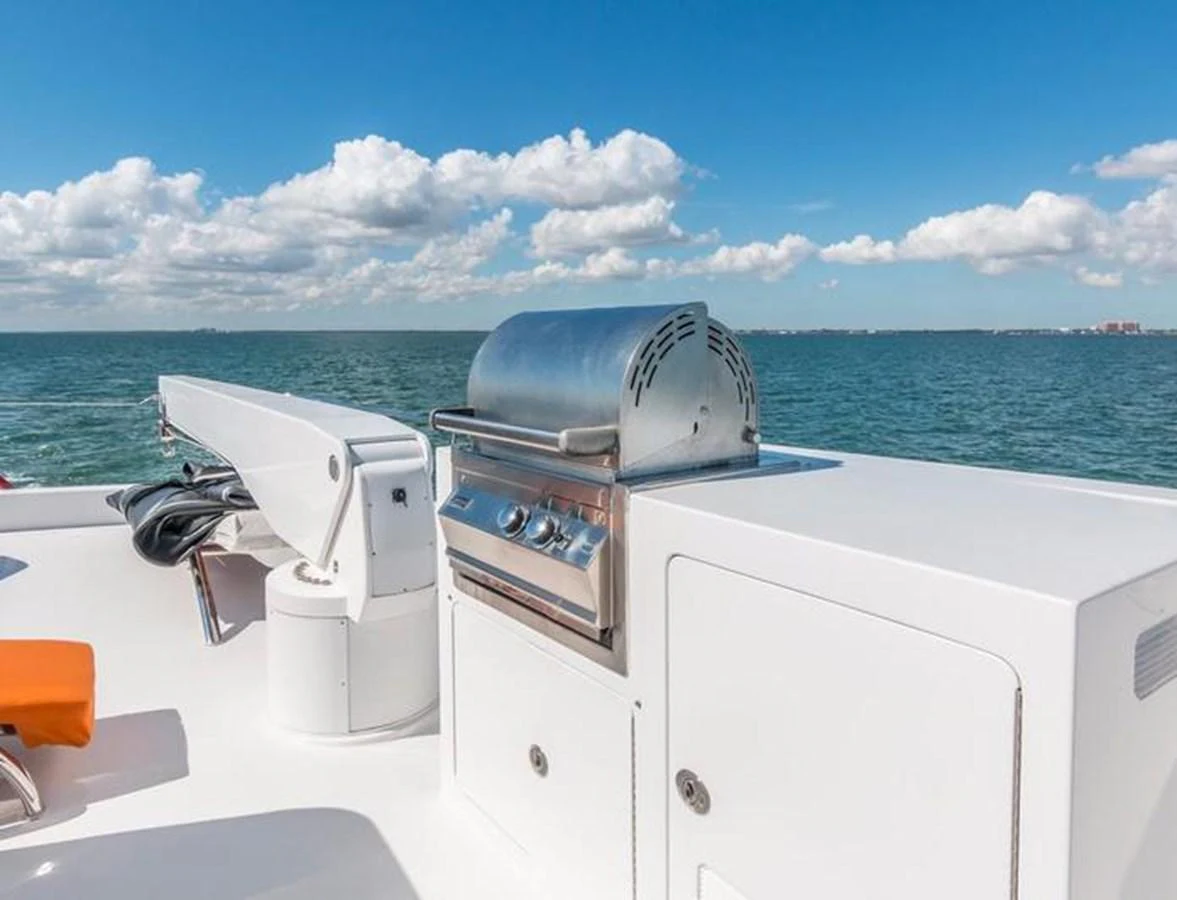 The yacht features a sleek outdoor grill area with stunning ocean views. aboard ROBIN'S NEST Yacht for Sale