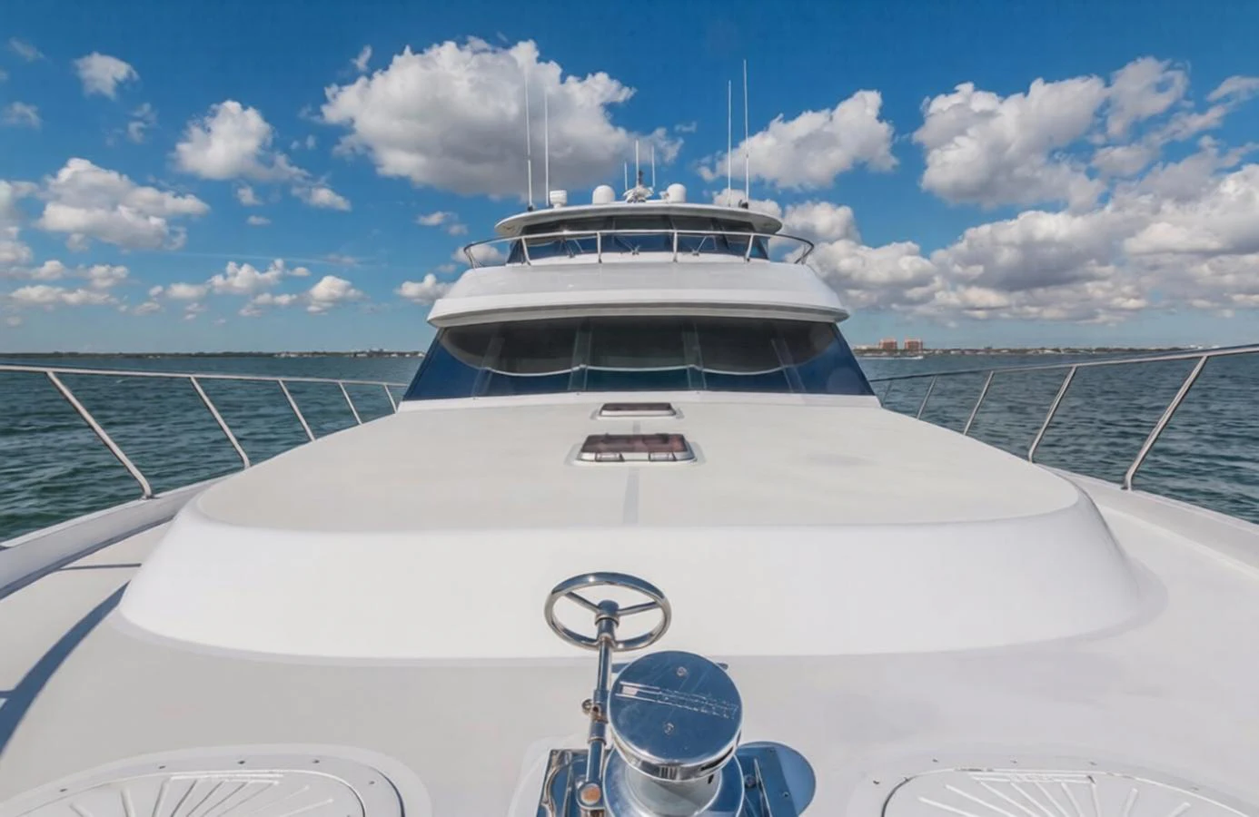 The yacht's bow is showcased against a backdrop of blue skies and calm waters. aboard ROBIN'S NEST Yacht for Sale