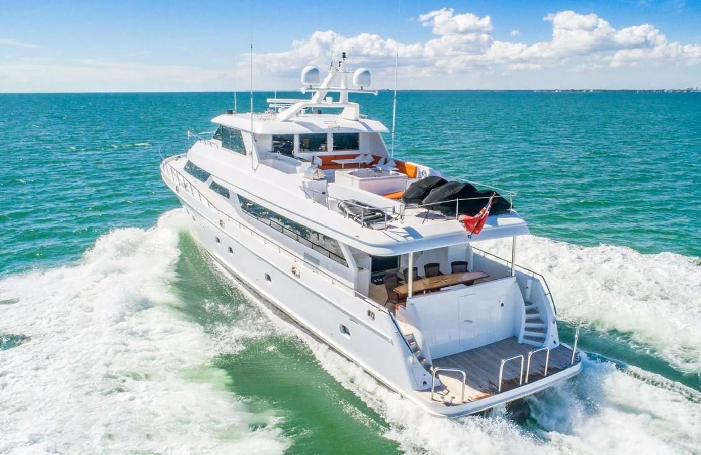 A luxurious yacht cruises through the open sea, showcasing its sleek design and spacious aft deck. aboard ROBIN'S NEST Yacht for Sale