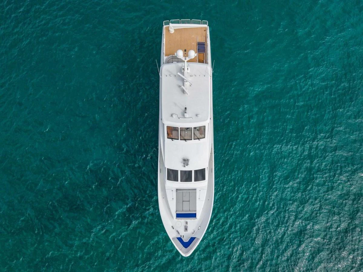 Aerial view of a sleek yacht cruising through clear blue waters. aboard BOBBI TOO Yacht for Sale