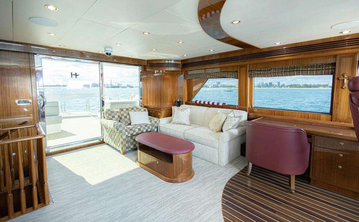 The salon features comfortable seating with a view of the water through large windows. aboard BOBBI TOO Yacht for Sale