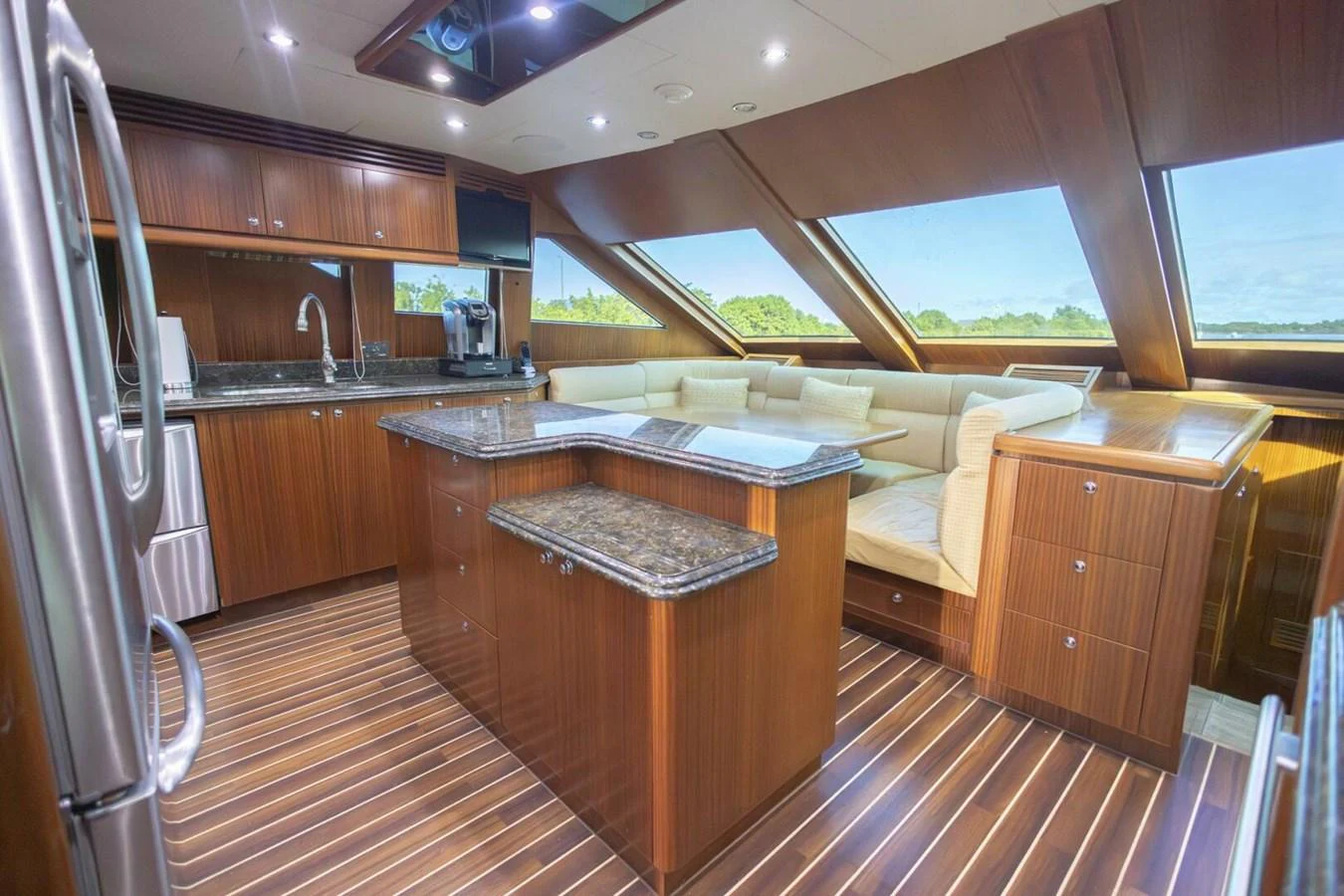 The yacht's galley features modern appliances, ample counter space, and a cozy seating area with panoramic windows. aboard BOBBI TOO Yacht for Sale