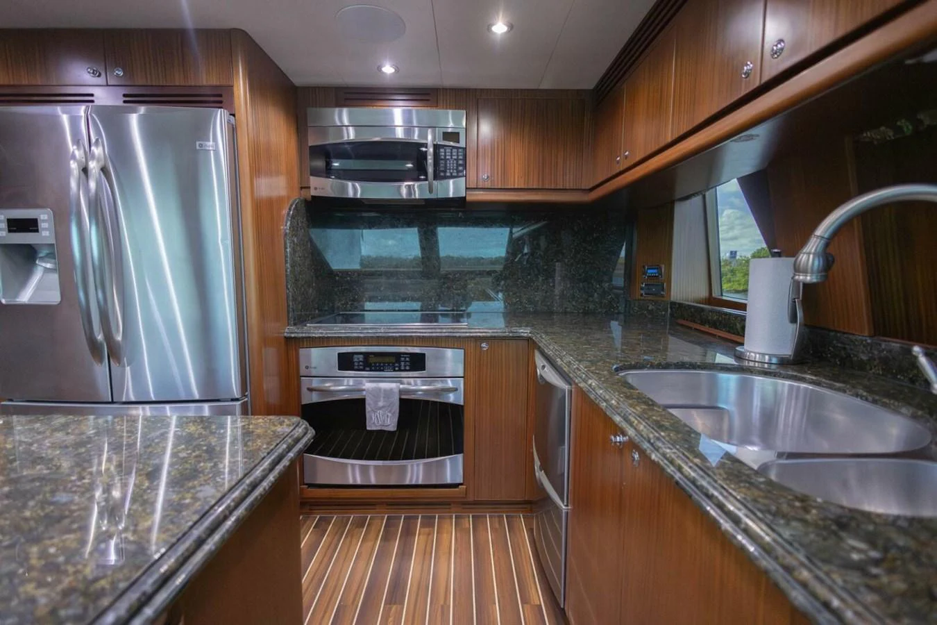The yacht's galley features modern stainless steel appliances and elegant wood cabinetry. aboard BOBBI TOO Yacht for Sale