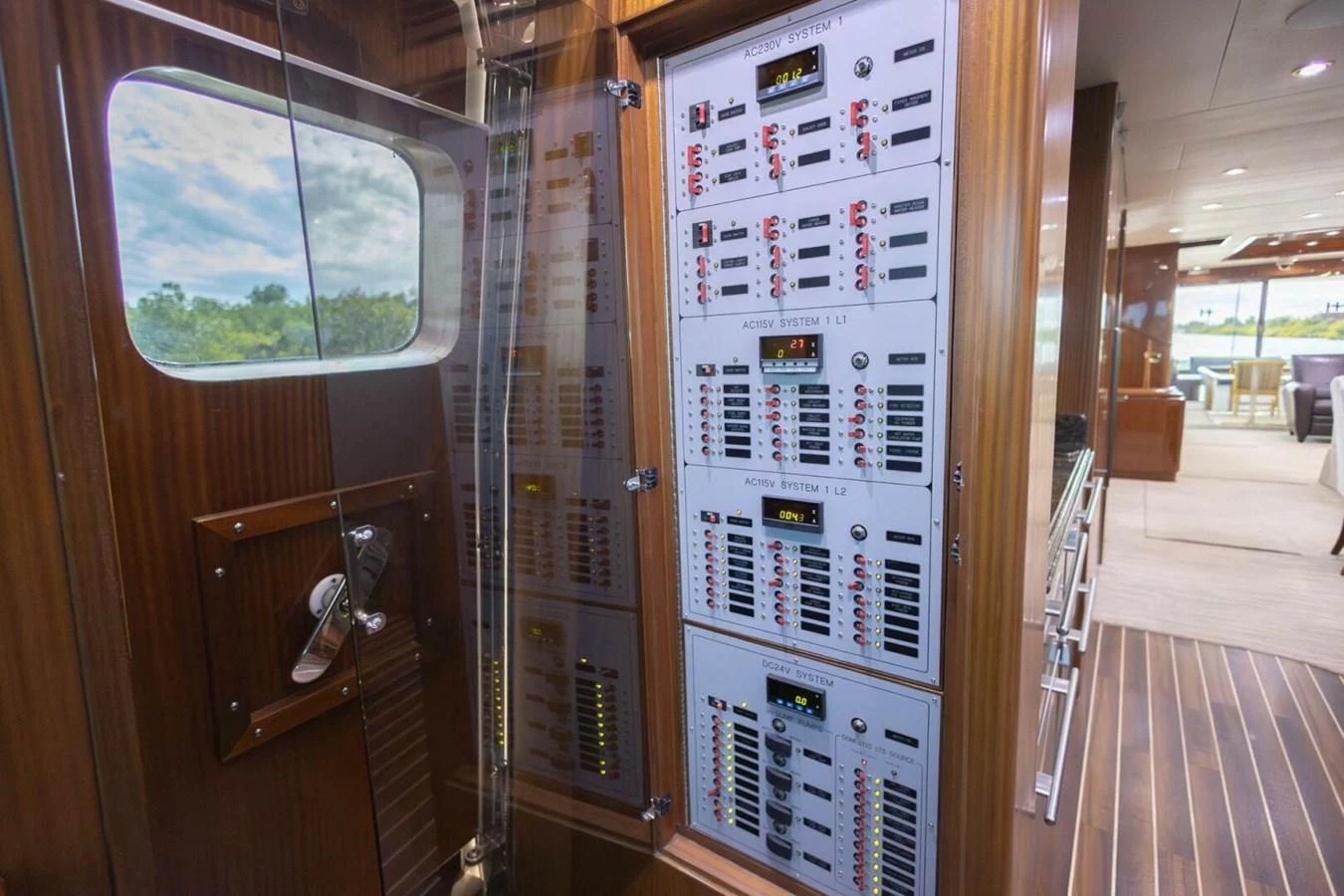 The yacht's sophisticated control panel is neatly organized within a polished wooden cabinet. aboard BOBBI TOO Yacht for Sale