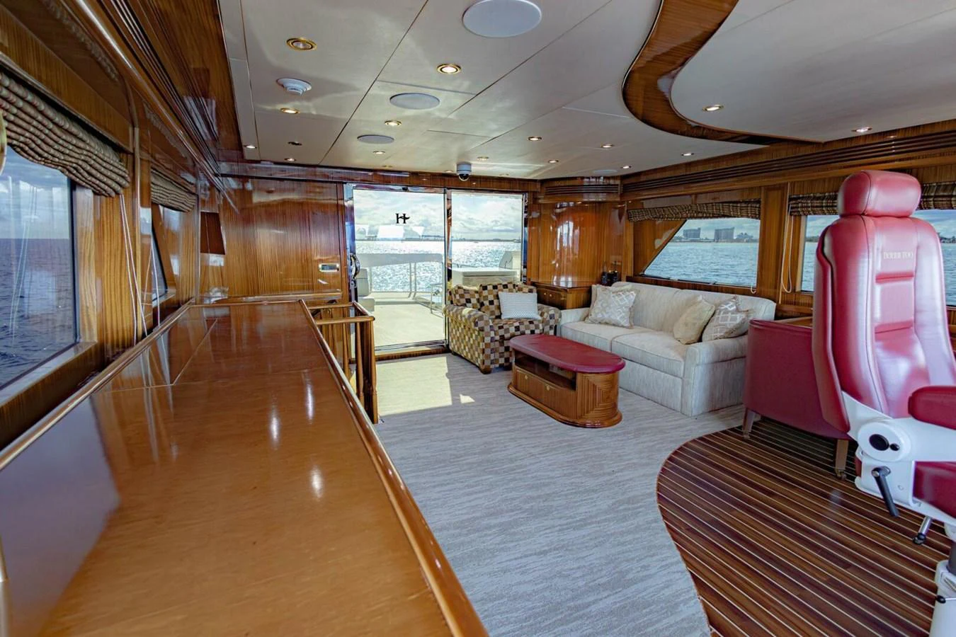 The salon features luxurious seating with panoramic views and elegant wood finishes. aboard BOBBI TOO Yacht for Sale